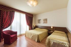 Postel nebo postele na pokoji v ubytování Hotel Doge