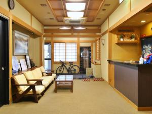 a living room with a couch and a table at おばな旅館 富貴亭 in Nagano