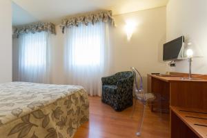 Postel nebo postele na pokoji v ubytování Hotel Doge