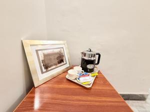 a table with a coffee maker and cups on it at Atlas Gold Hotel in Islamabad +39 photos