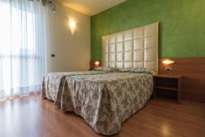 Postel nebo postele na pokoji v ubytování Hotel Doge