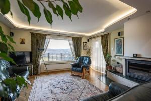 a living room with a chair and a fireplace at House 46 in Veliko Tŭrnovo