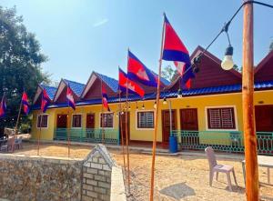 a row of flags in front of a building at KOHRONG khmerhome in Kaôh Rŭng (3)
