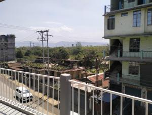a white car parked on a balcony of a building at Windfall Homestay in Dimapur