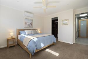 a bedroom with a large bed with blue sheets at My Place, McCrae in McCrae