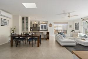 a living room and kitchen with a table and a couch at My Place, McCrae in McCrae