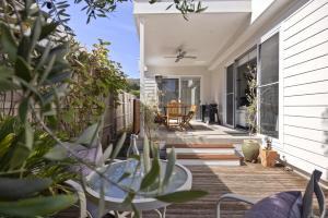 a deck with a table and chairs on a house at My Place, McCrae in McCrae