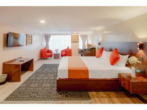 a hotel room with a bed and a living room at Karen Plains Hotel Nairobi in Nairobi +84 photos