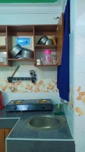 a kitchen with a counter with a sink in it at Bamburi Mombasa two bedrooms at Cutraz homes villa 003 in Mombasa +5 photos