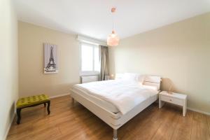 a bedroom with a white bed and a window at RELOC Serviced Apartments Wallisellen Bhf. in Wallisellen