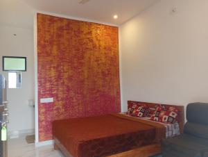 a bedroom with a bed and a colorful wall at Leaf mountain view holidays rooms in Vagamon