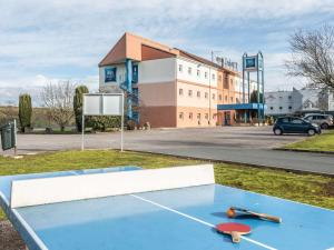 a ping pong table in front of a building at ibis budget Bourges in Bourges