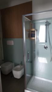 a bathroom with a shower and a toilet and a sink at Cristina Home in Taranto