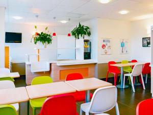 a classroom with tables and colorful chairs at Ibis Budget Honfleur Centre Ville in Honfleur