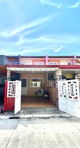 a house with two white doors in front of it at Calapan Transient House Xevera in Calapan