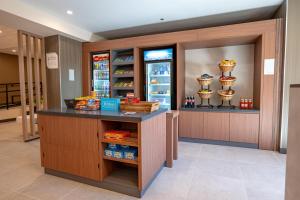 a store with a counter with food in a refrigerator at Hilton Garden Inn Clackamas Portland in Clackamas