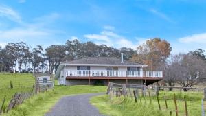a house on a hill with a dirt road at Hillside Farm in Mittagong +16 photos