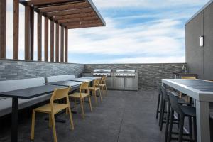 a row of tables and chairs on a patio at Home2 Suites By Hilton Big Spring in Big Spring