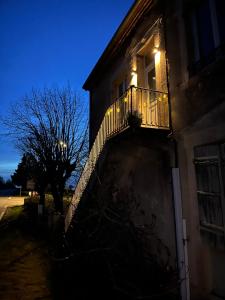 a building with a balcony with lights on it at Cercy in Cercy-la-Tour