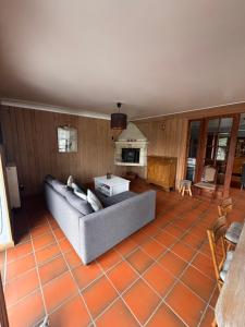 a living room with a couch and a fireplace at Le Durbuy Lodge in Durbuy