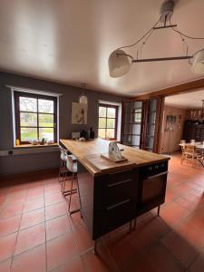 a kitchen with a large island with a wooden counter top at Le Durbuy Lodge in Durbuy