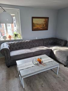 a living room with a couch and a table at Ellens Farm in Kolkwitz