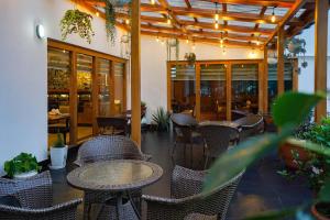 a patio with wicker chairs and tables in a restaurant at CityHotel, Thimphu in Thimphu