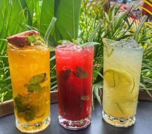 a group of three cocktails sitting on a table at Hostel Cafe13 in Ko Phangan +26 photos