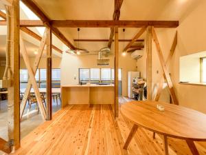 a kitchen and dining room with a wooden table at Beppu TOJIHAUS 001 2min walk to Shibaseki Onsen in Beppu