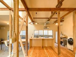 a kitchen and dining room with wooden beams at Beppu TOJIHAUS 001 2min walk to Shibaseki Onsen in Beppu