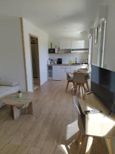 a living room with a couch and a table at Studio de Marie in Bordeaux-Saint-Clair