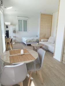 a living room with a table and chairs and a couch at Studio de Marie in Bordeaux-Saint-Clair +4 photos