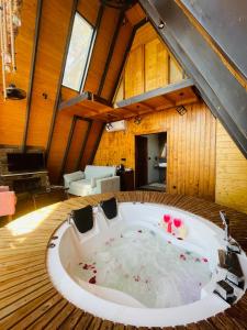 a large bath tub in the middle of a room at Koro Treehouse Resort Luxury Jacuzzi Cottages and Jacuzzi Villas in Kasauli +66 photos