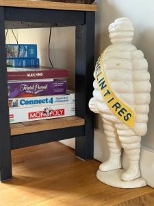 a stack of books next to a book shelf at The Old Garage in Rural Northumberland in Edlingham