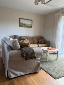 a living room with a couch and a table at The Old Garage in Rural Northumberland in Edlingham