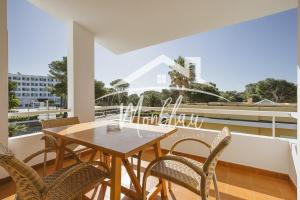 a dining room with a table and chairs on a balcony at Sa Torreta 4 in Cala Blanca
