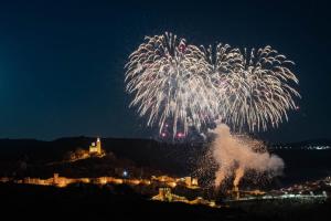 a firework display at night with a city in the background at House 46 in Veliko Tŭrnovo +30 photos