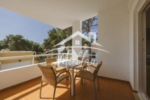 a dining room with a table and chairs on a balcony at Sa Torreta 3 in Cala Blanca