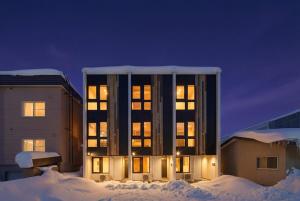 a building with the lights on in the snow at ZABOCON Honcho Terrace in Sapporo