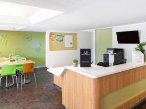 a waiting area of a dental office with a counter at ibis Budget - Newcastle in Newcastle +14 photos