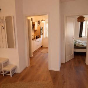a kitchen and a living room with a hard wood floor at Gutshof 1600 in Hohnstein