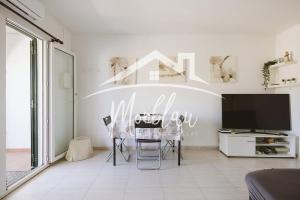 a living room with a table and chairs and a tv at Saray Son Alma in Son Carrio