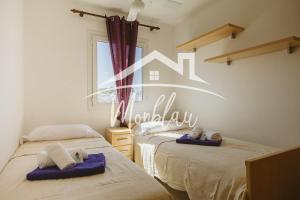 a bedroom with two beds with towels on them at Saray Son Alma in Son Carrio +17 photos