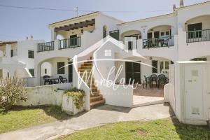a large white house with stairs in front of it at Saray Son Alma in Son Carrio
