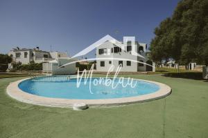 a house with a swimming pool in front of a house at Saray Son Alma in Son Carrio