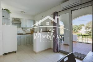 a kitchen with a sliding glass door to a balcony at Saray Son Alma in Son Carrio