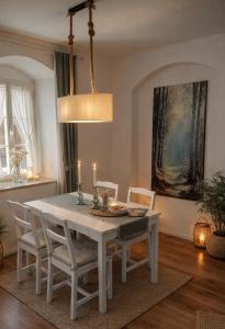 a dining room with a white table and chairs at Gutshof 1600 in Hohnstein