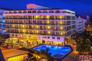 a hotel with a swimming pool at night at Sunbay Park Hotel in Marmaris