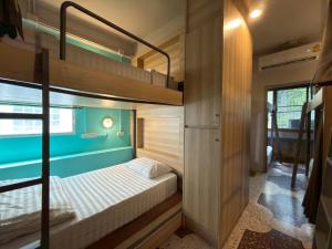 a bedroom with a bunk bed in a house at Merge Hostel Chinatown in Samphanthawong