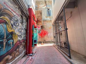 an alley with a painting on the side of a building at Merge Hostel Chinatown in Samphanthawong